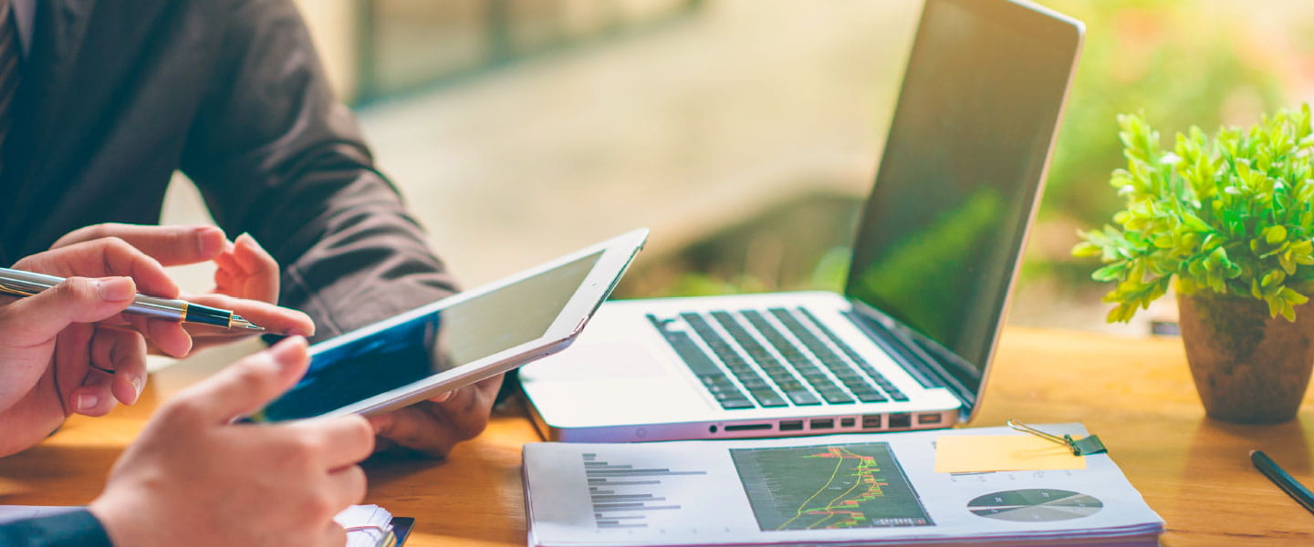 Two people working on a tablet