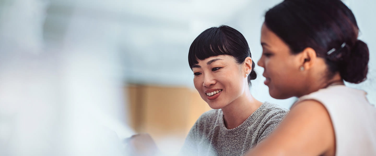 A man and woman looking at a tablet.