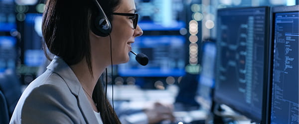 a women wearing glasses and headphone in front of a screen a women wearing glasses and headphone in front of a screen