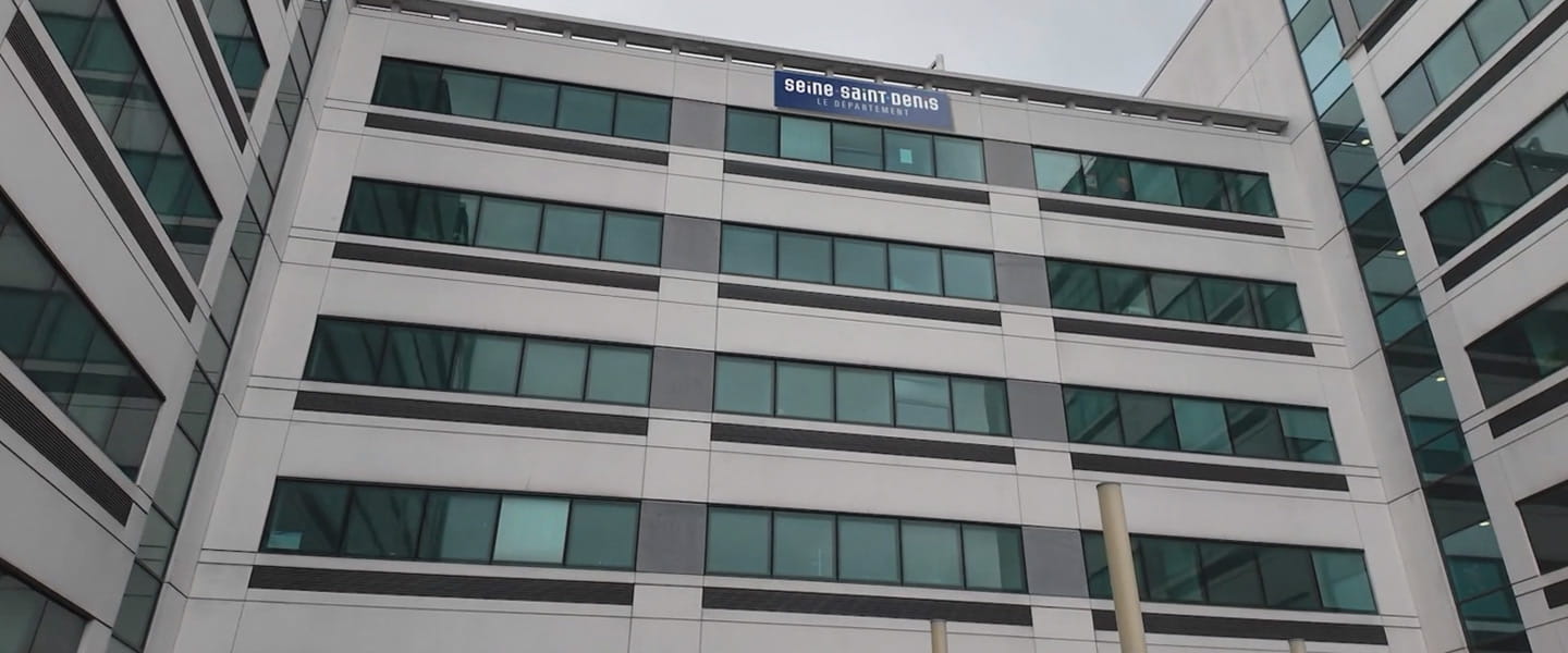 outside grey office building with glass windows