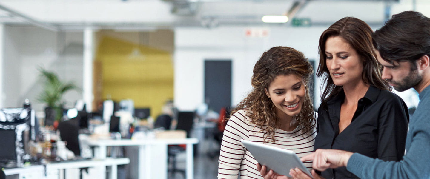 Three persons in a work environment