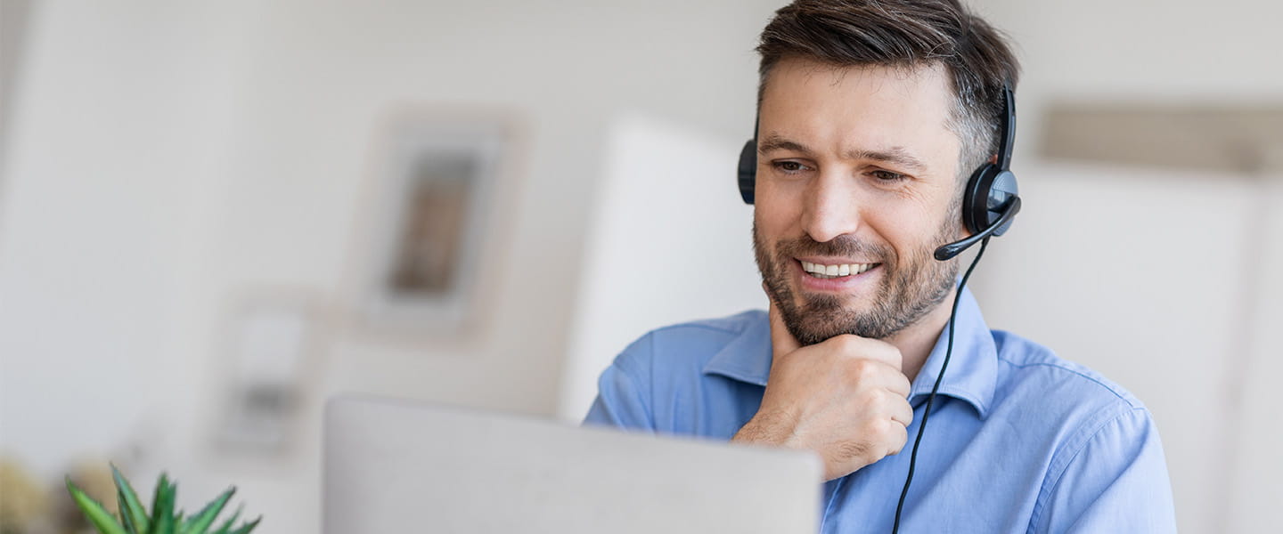 a smiling man wearing headphones