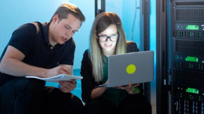 a man and a woman looking at a laptop a man and a woman looking at a laptop