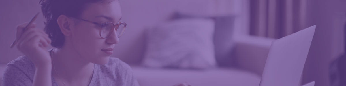 a young girl holding a pen