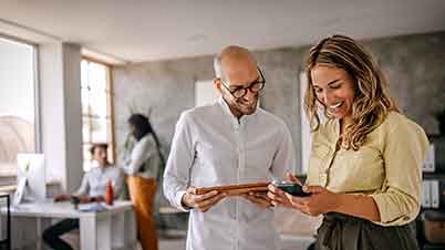 a man and a woman looking at a phone a man and a woman looking at a phone