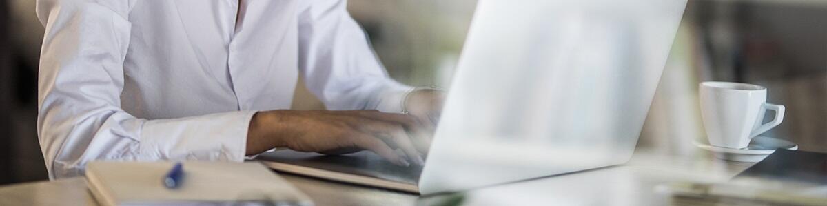 a man typing on a laptop keyboard a man typing on a laptop keyboard