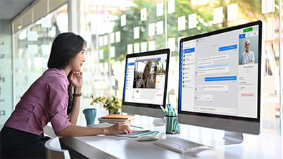 a woman in front of a computer screen a woman in front of a computer screen