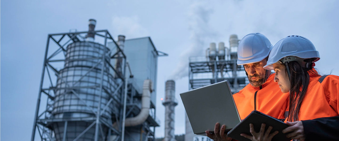 Energy/utility plant with two workers in hard hats