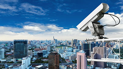 Video surveillance camera overlooking a city landscape