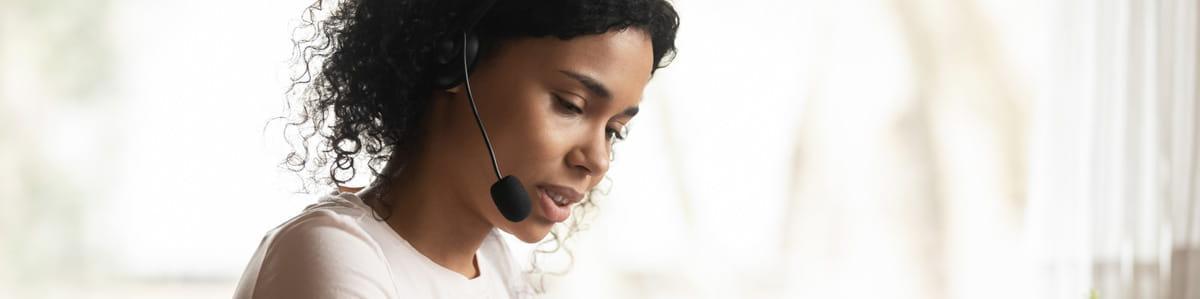 A women at work, with hearings and microphone