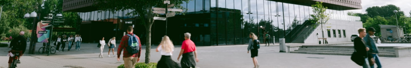a group of people walking around a building