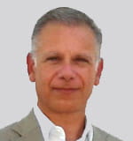 michel ozanian a man smiling for the camera