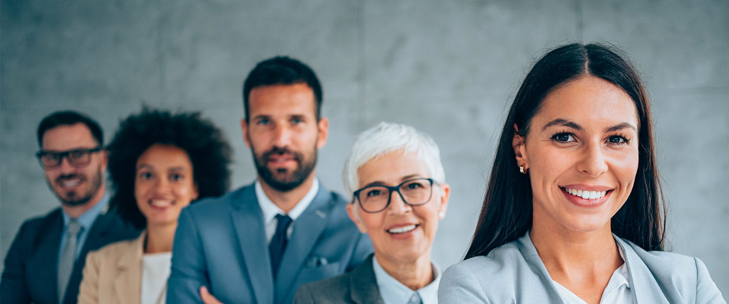 a group of smiling people looking at the camera