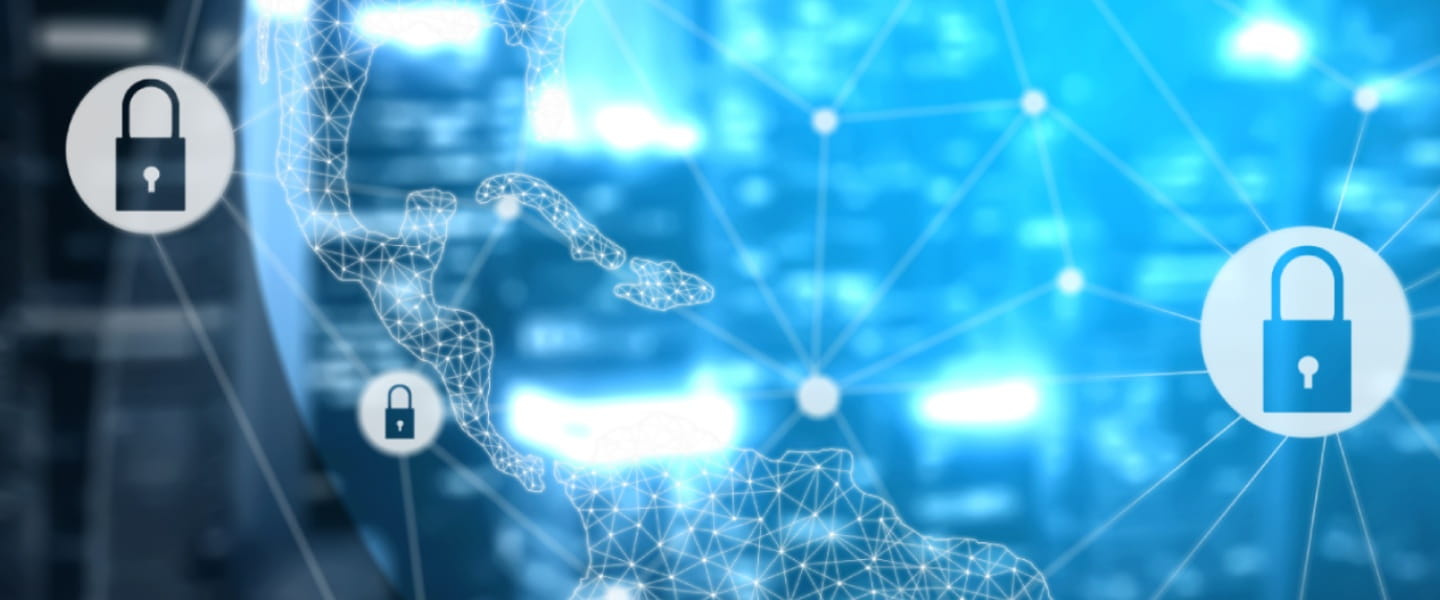 a person using a cell phone in front of a laptop