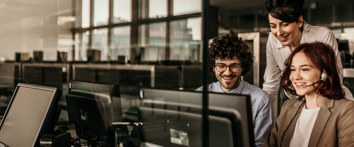 two women and a man behind a screen in a room