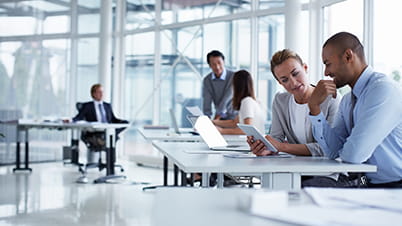 Business office space with man and woman at a desk