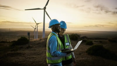A man and woman at a wind farm A man and woman at a wind farm