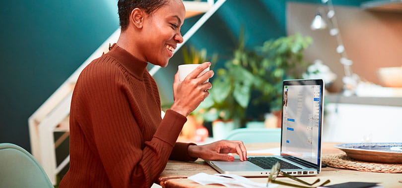 a man sitting at a table using a laptop