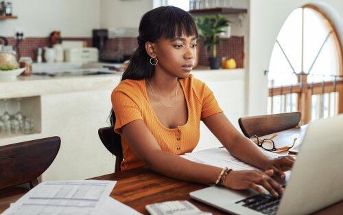 Woman working at kitchen table for blog post